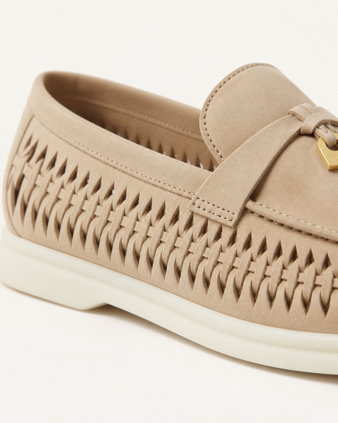Openwork woven side panels of the sand loafer