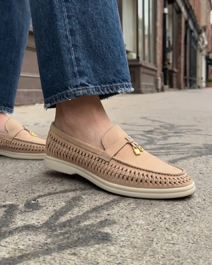 Sand Aureline loafers styled with wide-leg blue denim on a city sidewalk